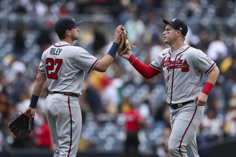 Atlanta Braves' Austin Riley (27) celebrates with Joc Pederson after they defeated the San Diego Padres in a baseball game Sunday, Sept. 26, 2021, in San Diego. (AP Photo/Derrick Tuskan)