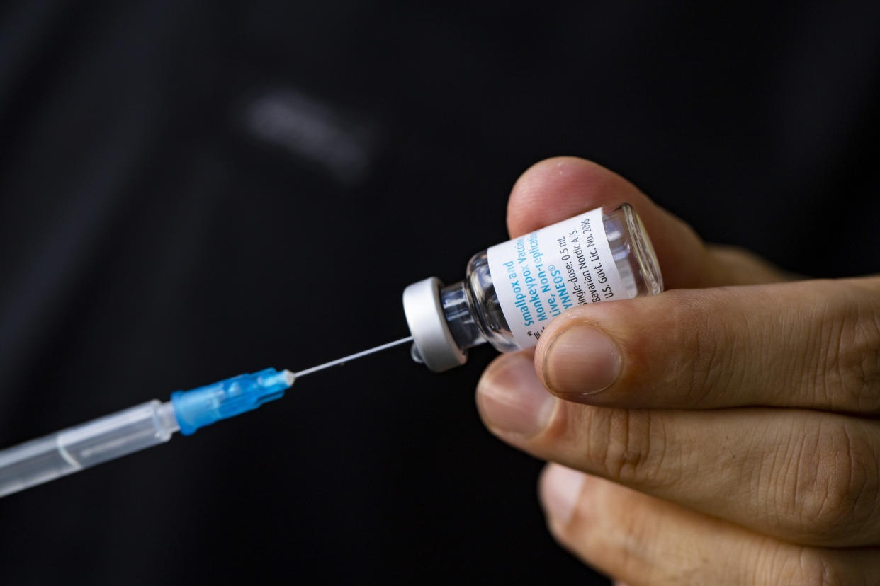 A hypodermic needle and mpox vaccine.