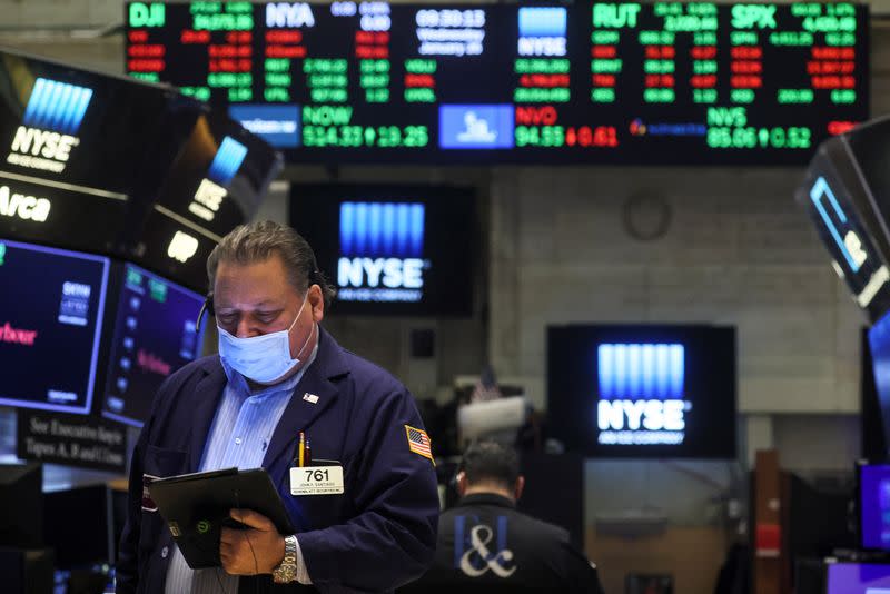 Traders work on the floor of the NYSE in New York