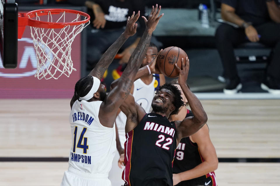 Miami Heat forward Jimmy Butler (22) drives to the basket against Indiana Pacers forward JaKarr Sampson (14) during the second half of an NBA basketball first round playoff game, Saturday, Aug. 22, 2020, in Lake Buena Vista, Fla. (AP Photo/Ashley Landis, Pool)
