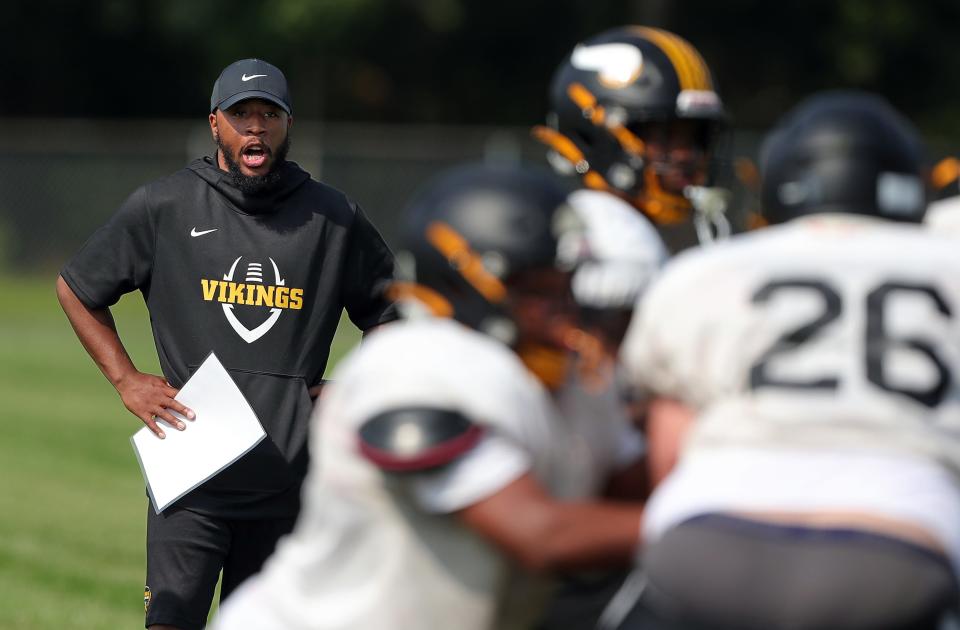 North coach DeMonte Powell looks on as his team runs a goal-line play in practice on Aug. 3.