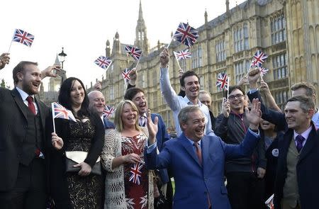 Nigel Farage (front), the leader of the United Kingdom Independence Party (UKIP) reacts with supporters, following the result of the EU referendum, outside the Houses of Parliament in London, Britain June 24, 2016. REUTERS/Toby Melville