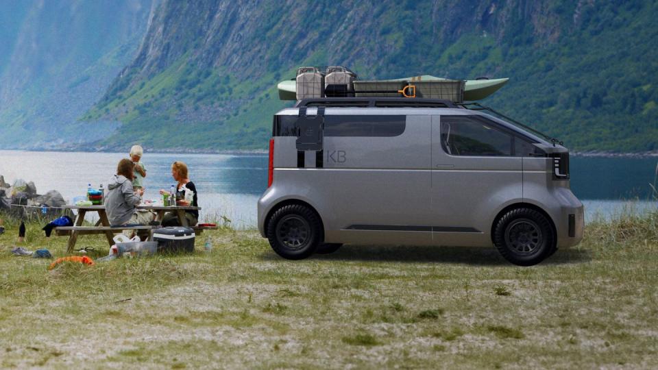 a van parked on grass by a body of water