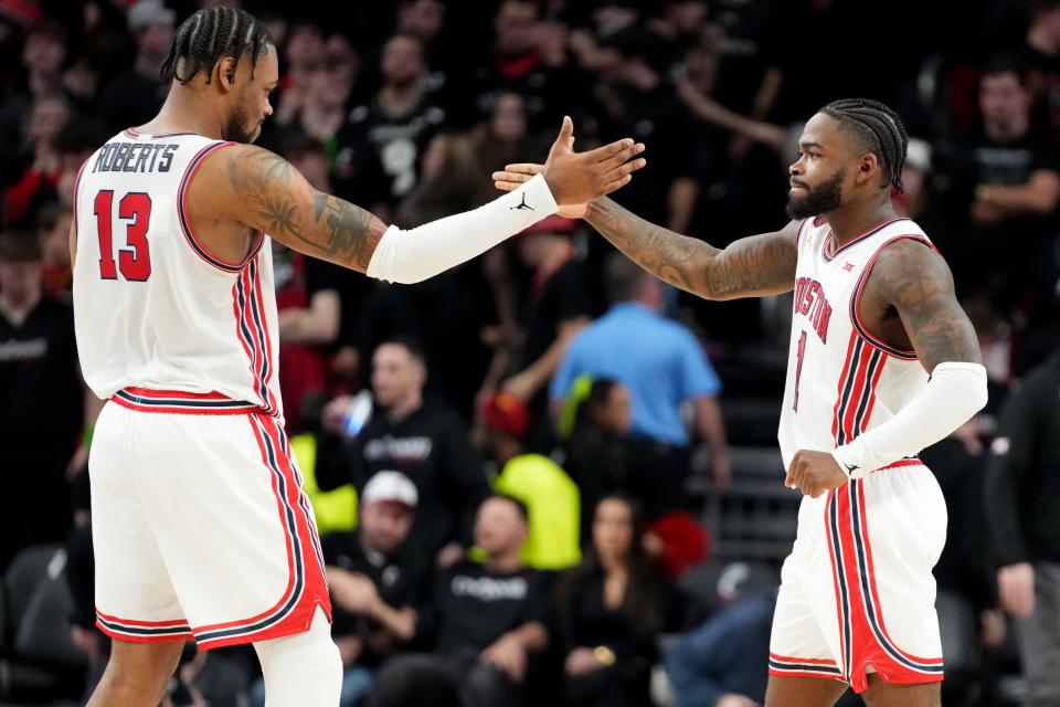 Houston Cougars forward J'Wan Roberts (13) and Houston Cougars guard Jamal Shead (1) celebrate the win over Cincinnati in Fifth Third Arena Feb. 10. The Cougars host the Bearcats Tuesday night in Houston.