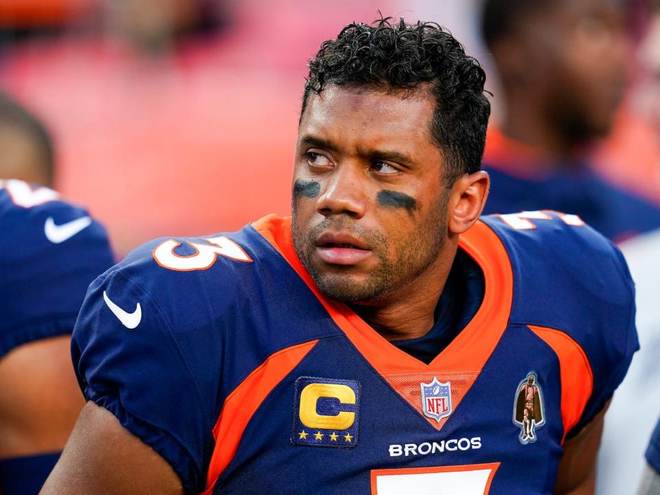 Russell Wilson frowns as he looks off to the side during a Broncos game.