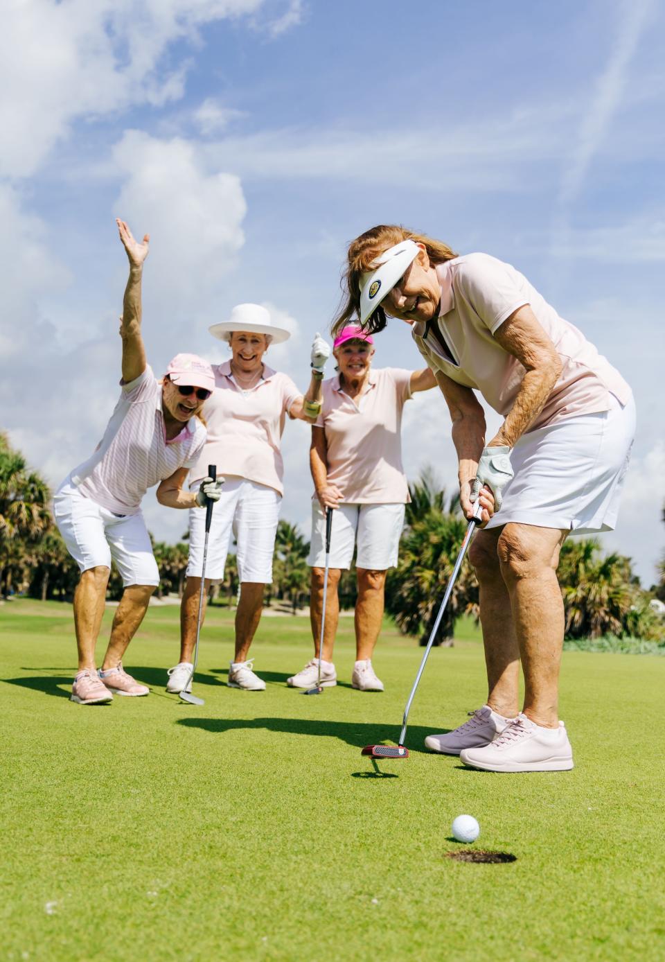 Palm Beach Gardens residents Maryanne Jones, Patti Collins and Sharyn Petillo cheer on Ronnie Stein,  as she putts during the seventh annual Literacy Links golf tournament April 14, 2023 at the Par 3 golf course in Palm Beach.