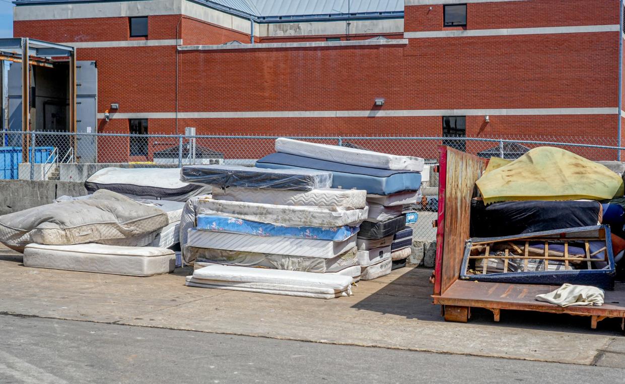 Old mattresses are hard to get rid of in Providence, so they end up on roadsides, in vacant lots and in other illegal repositories. Here, a stack of throw-outs at a city mattress depot on Allens Avenue.