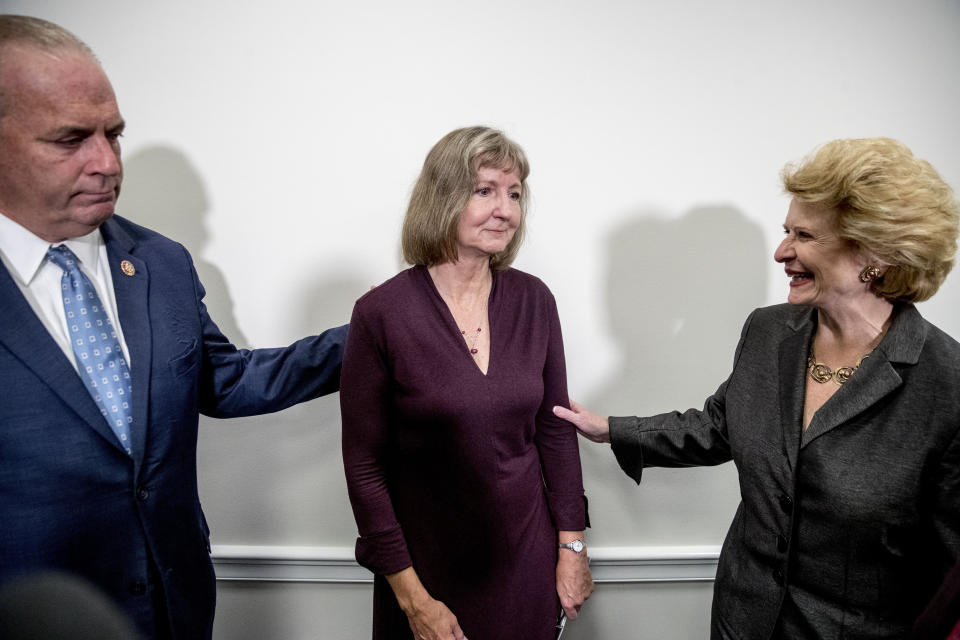 Rep. Dan Kildee, D-Mich., left, Sen. Debbie Stabenow, D-Mich., right, and Elizabeth Whelan, the sister of Paul Whelan, center, speak following a news conference on Capitol Hill in Washington, Thursday, Sept. 12, 2019, to call on Congress to pass a resolution condemning the Russian government for detaining Paul Whelan. (AP Photo/Andrew Harnik)