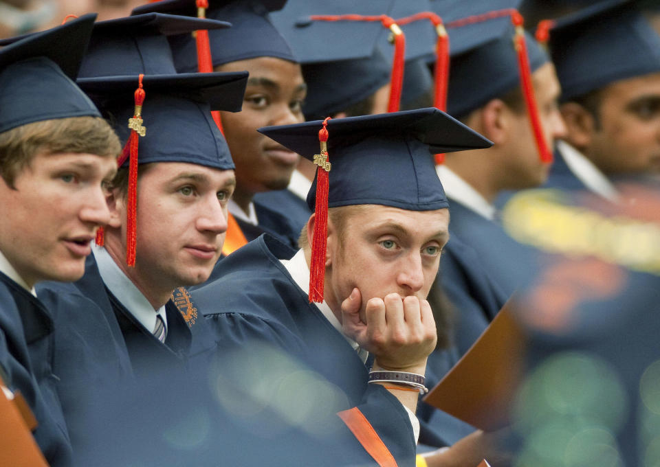 A graduate rests his head in his hand during Syracuse University's commencement ceremony at the Carrier Dome in Syracuse, New York, U.S., on Sunday, May 16, 2010. Students entering one of the weakest job markets in history need to have the courage to speak the truth, 'even when it's unpopular,' JPMorgan Chase & Co. Chief Executive Officer Jamie Dimon told graduates. Photographer: Michael Okoniewski/Bloomberg via Getty Images