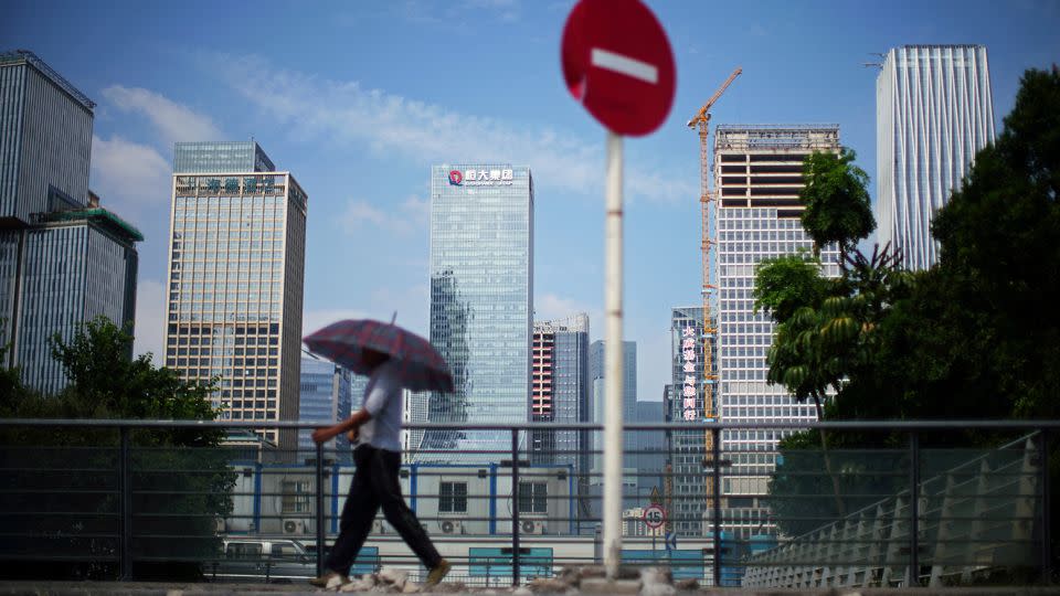 A man walks past a No Entry traffic sign near the headquarters of China Evergrande Group in Shenzhen, Guangdong province, China September 26, 2021. - Aly Song/Reuters