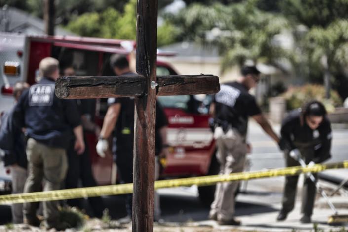 Los Angeles Fire Department Arson Unit personnel gather forensic evidence outside the Sylmar Christian Fellowship Church on Thursday, July 6, 2023, in the Sylmar section of Los Angeles. (AP Photo by Richard Vogel)