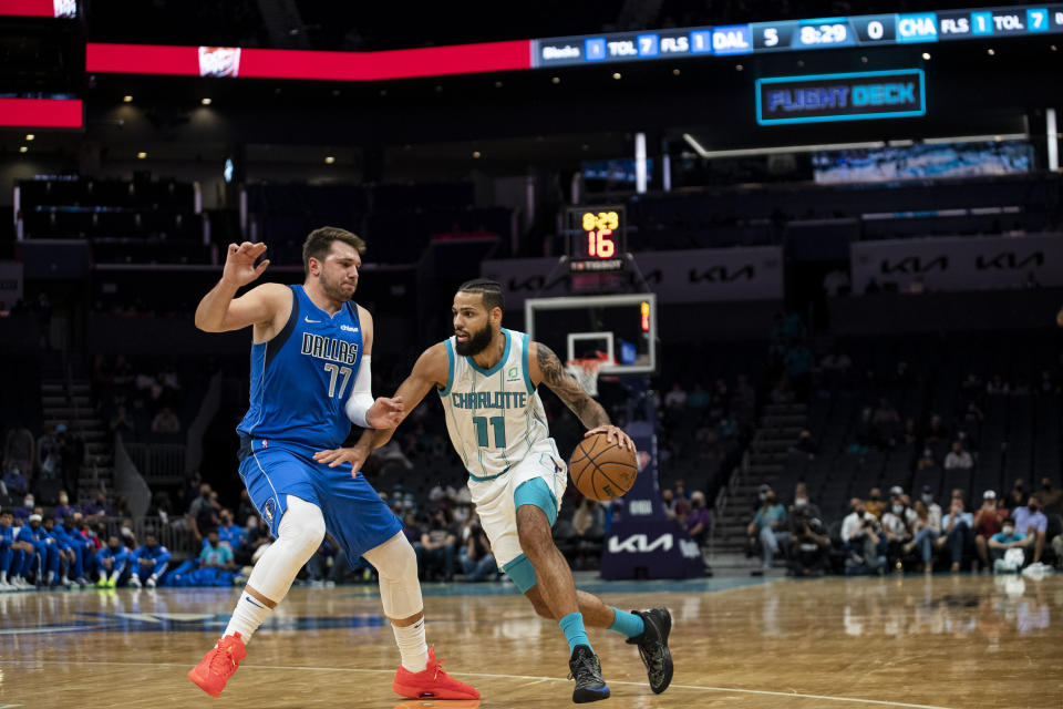 Charlotte Hornets forward Cody Martin (11) is defended by Dallas Mavericks' Luka Doncic during the first half of an NBA preseason basketball game Wednesday, Oct. 13, 2021, in Charlotte, N.C. (AP Photo/Matt Kelley)