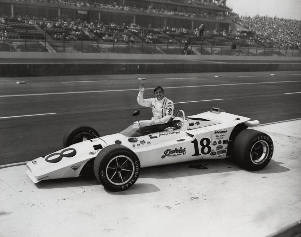 Indy car driver Johnny Rutherford poses next to his car before the California 500 at Ontario Motor Speedway in 1970.