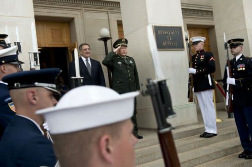 US Secretary of Defense Leon Panetta (L) and Chinese Defense Minister Gen. Liang Guanglie listen to the Chinese national anthem during an honor cordon prior to talks at the Pentagon