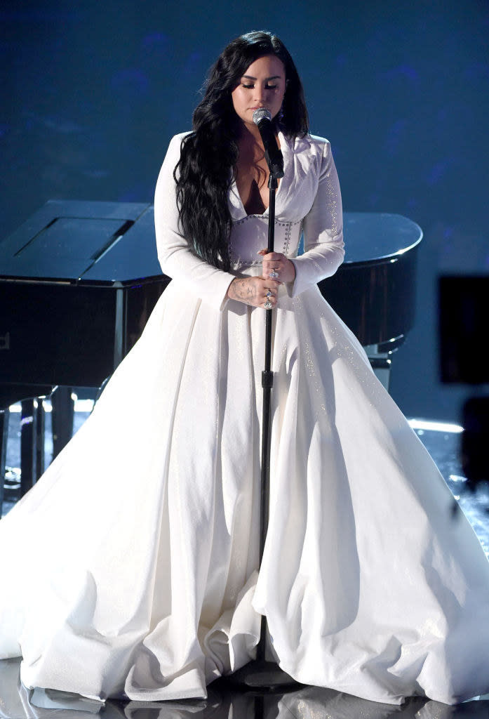 long-sleeved, wedding dress-like gown with a deep V neckline and billowing skirt