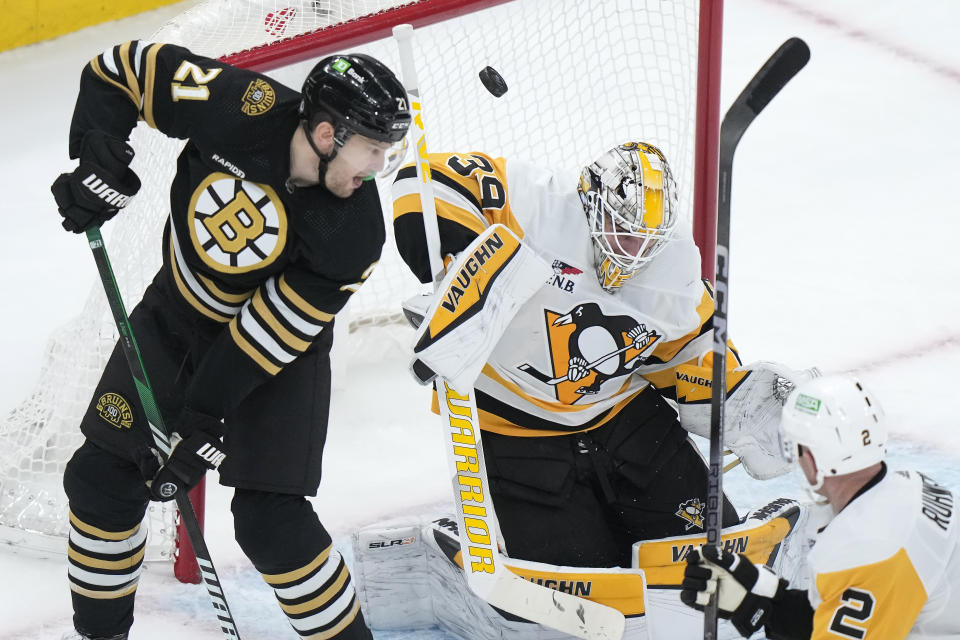 Boston Bruins left wing James van Riemsdyk (21) tries to score as Pittsburgh Penguins goaltender Alex Nedeljkovic (39) deflects the puck away from the net in the second period of an NHL hockey game, Thursday, Jan. 4, 2024, in Boston. (AP Photo/Steven Senne)