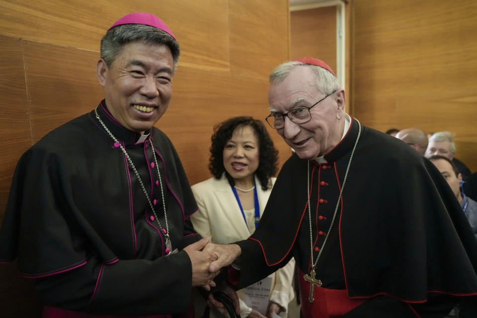 Shangai Bishop Joseph Shen Bin, left, shakes hands with Vatican Secretary of State, Cardinal Pietro Parolin during an international conference to celebrate "100 years since the Concilium Sinense: between history and the present" celebrating the First Council of the Catholic Church in China, organized by the Pontifical Urbaniana University, in Rome, Tuesday, May 21, 2024. (AP Photo/Andrew Medichini)