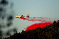 An air tanker drops retardant while battling the Kincade Fire near Healdsburg, Calif., on Tuesday, Oct. 29, 2019. The overall weather picture in northern areas is improving, as powerful, dry winds bring extreme fire weather to Southern California. (AP Photo/Noah Berger)
