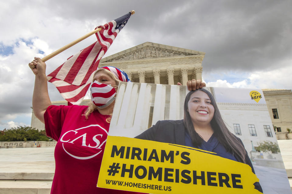 Ivania Castillo from Prince William County, Va., holds a banner to show her support for dreamer Miriam from California, as she joins Deferred Action for Childhood Arrivals (DACA) recipients celebrate in front of the U.S. Supreme Court after the Supreme Court rejected President Donald Trump's bid to end legal protections for young immigrants, Thursday, June 18, 2020, in Washington. (AP Photo/Manuel Balce Ceneta)