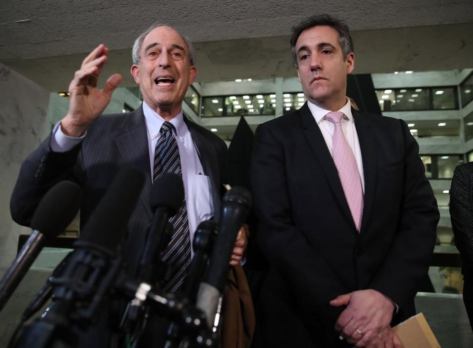 Mr Davis (left) speaks with Cohen after he testified to the Senate Intelligence Committee on Capitol Hill February 26, 2019 in Washington, DC, where he unveiled some information that is now being used in the hush money case (Getty)