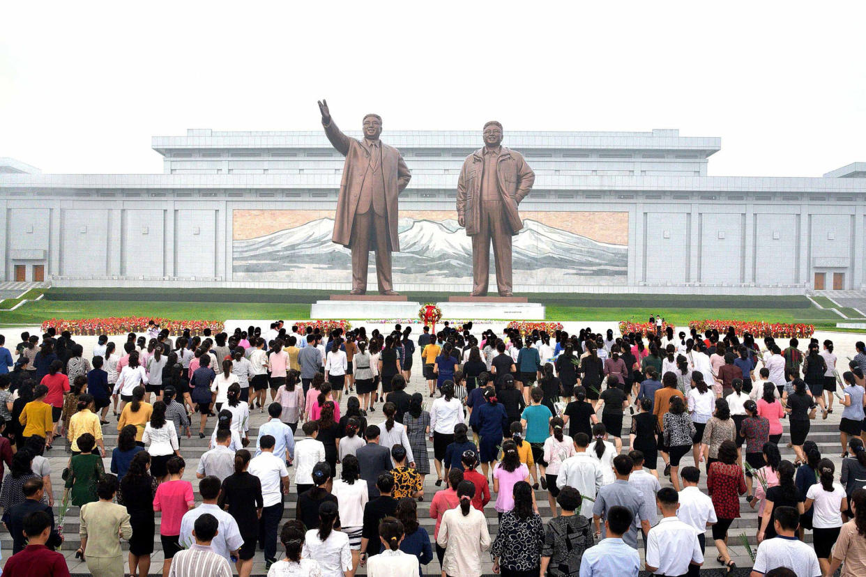 North Korean residents offer flowers before the statues of Kim Il-Sung and Kim Jong-Il during celebrations of the 69th anniversary of North Korea's founding: AFP/Getty Images