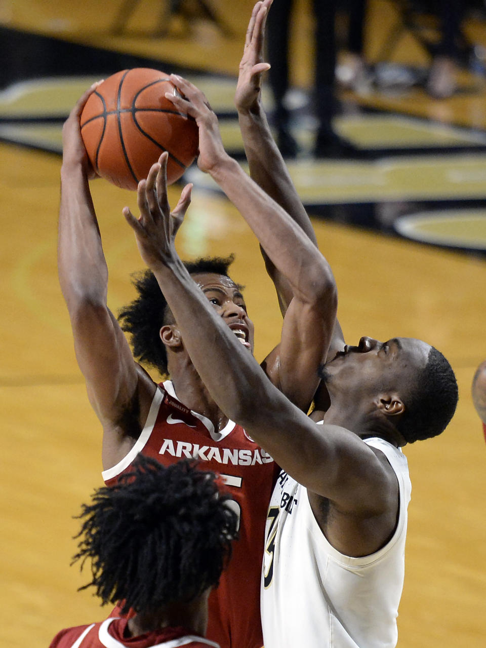 Arkansas guard Moses Moody, left, goes to the basket as Vanderbilt forward Clevon Brown (15) defends during the second half of an NCAA college basketball game, Saturday, Jan. 23, 2021, in Nashville, Tenn. Arkansas won 92-71. (AP Photo/Mark Zaleski)