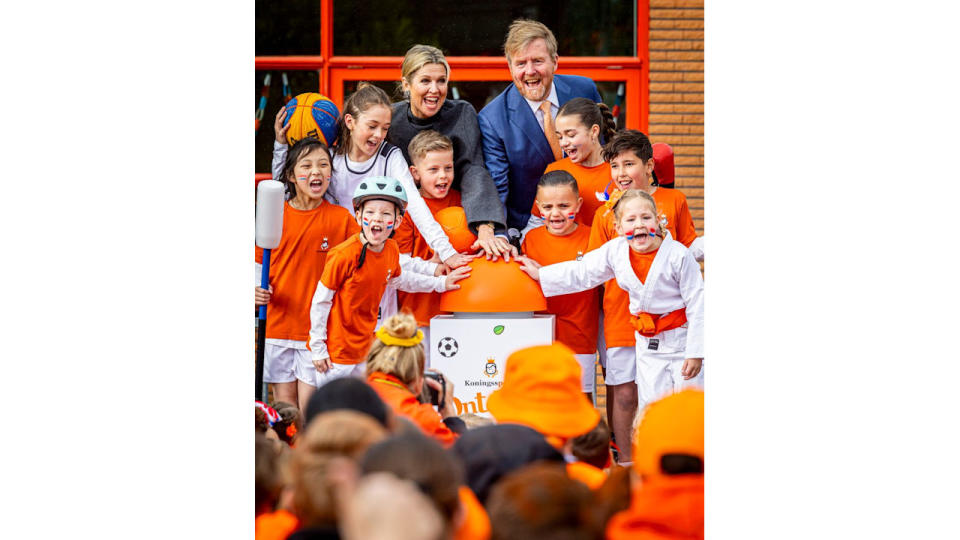 King Willem-Alexander and Queen Maxima with children cheering