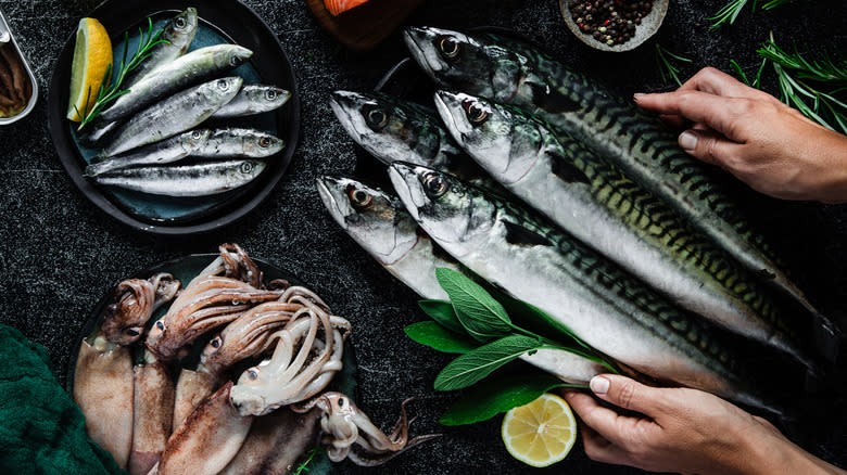 hands arranging fish