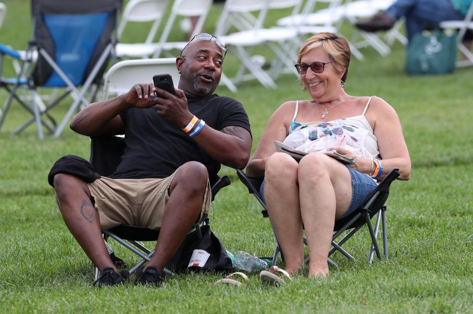 Jeff Onley, left, and Ellen Toy, of Maryland, relax during the Abbey Road on the River festival at Big Four Station Park in Jeffersonville.May 23, 2019