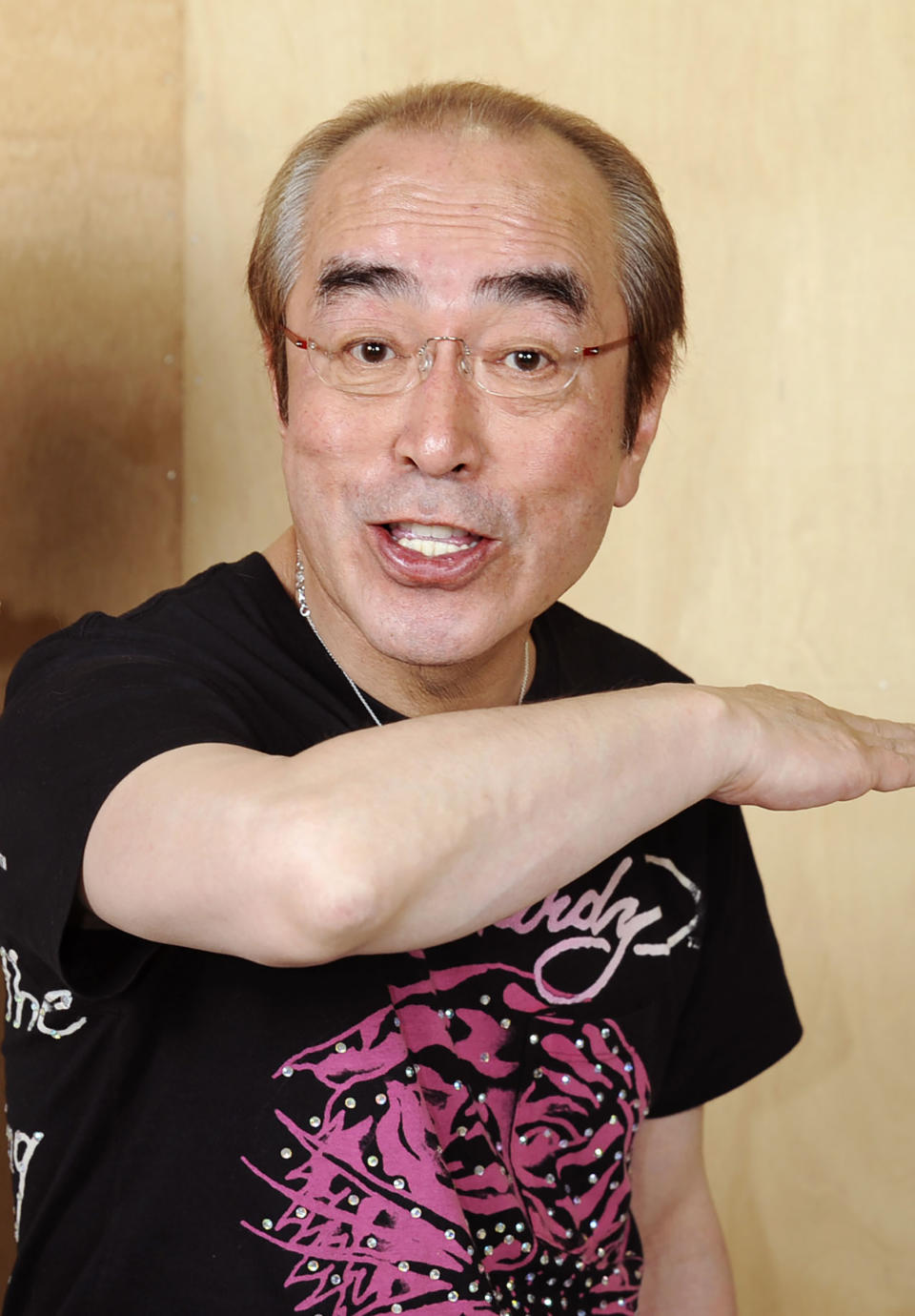 In this May 2012, photo, Japanese comedian Ken Shimura gestures with a funny face to a photographer in Tokyo. The nationally popular Japanese comedian, who said was drawing inspired from Jerry Lewis, has died of the COVID-19 pneumonia, a first known celebrity victim of the virus in Japan. He was 70. Shimura, who had fans of all generations with his slapstick jokes and funny faces, had been treated at a Tokyo hospital, died of the virus Sunday, March 29, 2020, his agency, Izawa Office, said. (Kyodo News via AP)