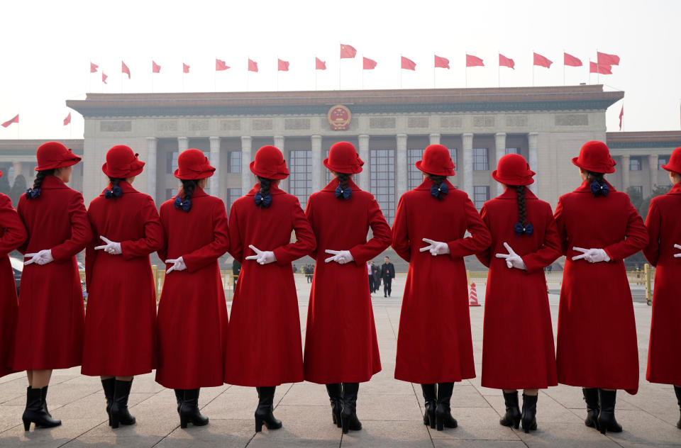 <p>Hotel ushers pose for a photo at Tiananmen Square as delegates attend the second plenary session of the National People’s Congress (NPC) in Beijing on March 9, 2018. (Photo: Jason Lee/Reuters) </p>