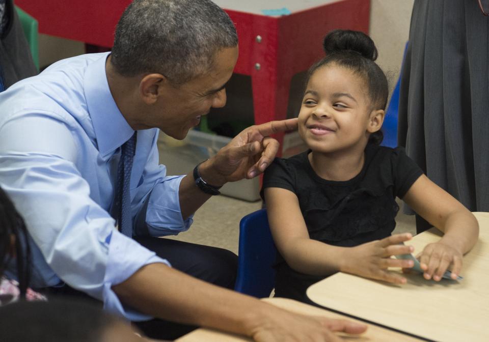 Obama talks with Akira Cooper during a visit to a classroom at the Community Children's Center in Lawrence, Kansas, in January 2015. (Photo: SAUL LOEB via Getty Images)