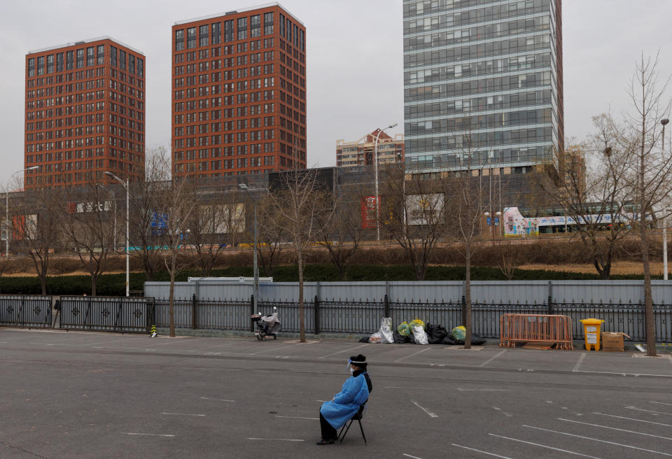 A security guard keeps watch outside a makeshift  fever clinic that was set up in a sports area as coronavirus disease (COVID-19) outbreaks continue in Beijing, December 20, 2022. REUTERS/Thomas Peter