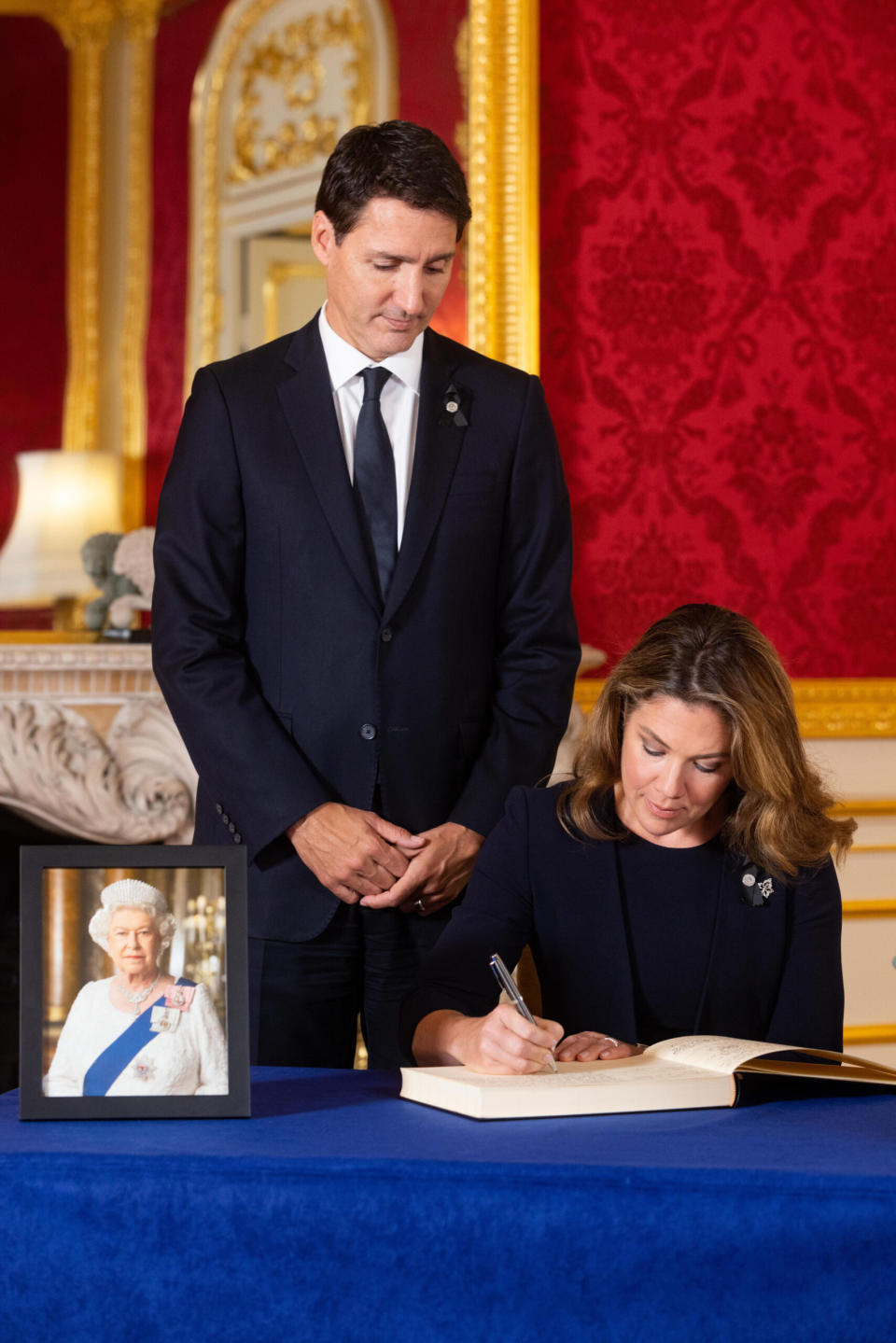 Prime Minister of Canada Justin Trudeau and his wife Sophe Trudeau sign a book of condolence at Lancaster House in London following the death of Queen Elizabeth II