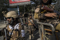 Fighters of the Haqqani network secure an area during a demonstration organised by the Afghan Society of Muslim Youth, demanding the release of frozen international money in Kabul, Afghanistan, Friday, Sept. 24, 2021. Afghanistan faces an economic meltdown after the chaos of the past month, which saw the Taliban oust the government in a lightning sweep as U.S. and NATO forces exited the 20-year war. (AP Photo/Bernat Armangue)