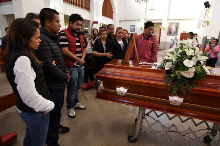 Relatives and friends of slain journalist Ricardo Monlui attend his funeral mass at a church in Cordoba, in the Mexican state of Veracruz, Mexico March 20, 2017. REUTERS/Yahir Ceballos