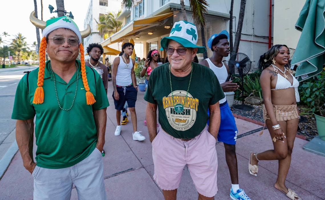 Toru Ikeda and Phil Harley celebrate St. Patrick’s Day while walking along Ocean Drive during spring break on Miami Beach, Florida on Sunday, March 17, 2024.