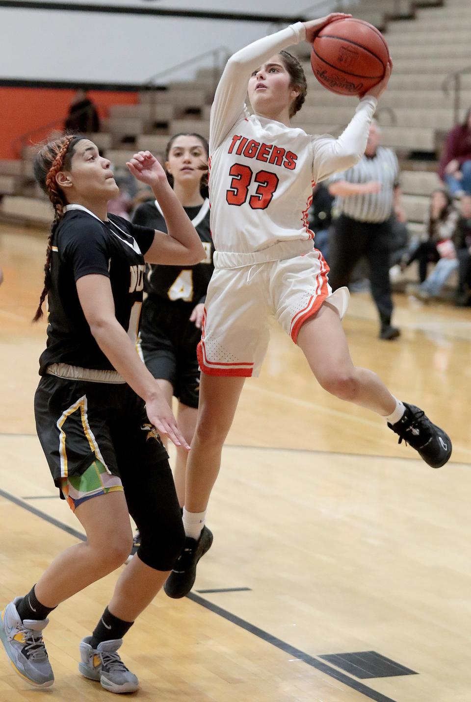 Massillon's Hanna Nicola looks to shoot with pressure from Akron North's Ce'Airah Underwood in the second half of Monday's game.