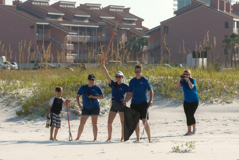 Volunteers pose for a photo at Park West Saturday, September 15, 2018 during International Coastal Cleanup Day.