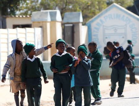 School pupils walk home from Kubatana Primary school in Epworth near Harare, Zimbabwe, July 5, 2016. REUTERS/Philimon Bulawayo