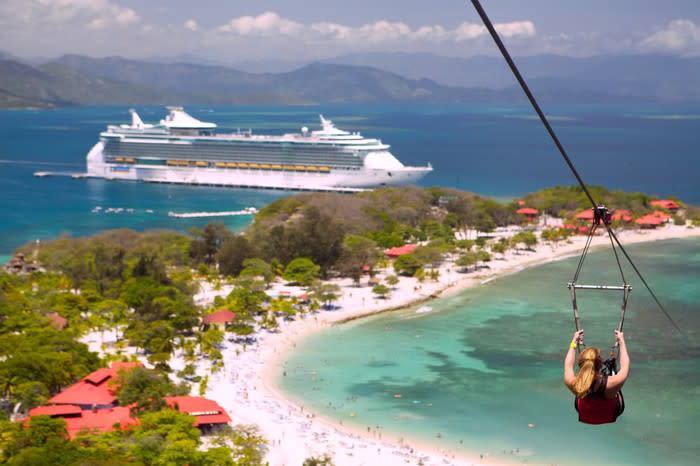 A guest zip-lining in Labadee at an RCL port-of-call.