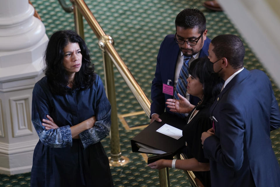 Texas state Sen. Carol Alvarado, D-Houston, talks with staff as she prepares to filibuster Senate Bill 1, a voting bill, at the Texas Capitol, Wednesday, Aug. 11, 2021, in Austin, Texas. (AP Photo/Eric Gay)