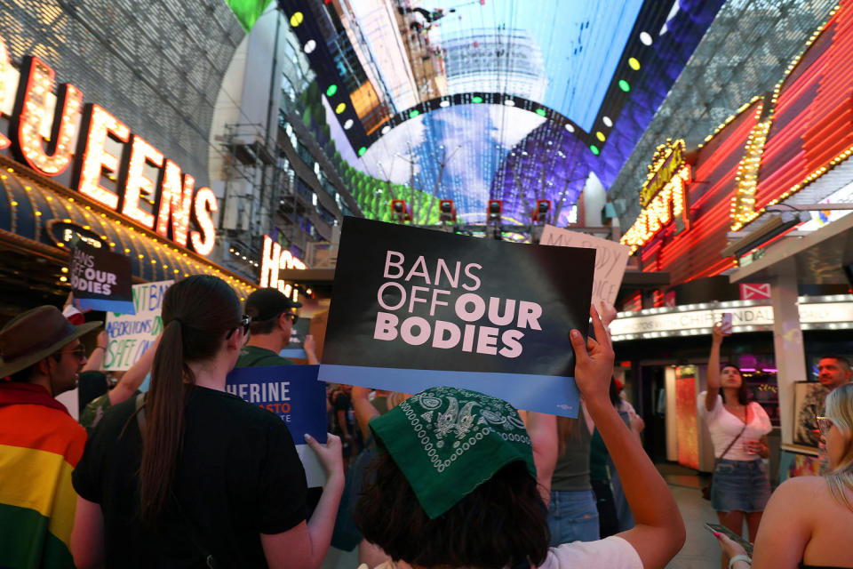 A protester holds a sign that reads, 