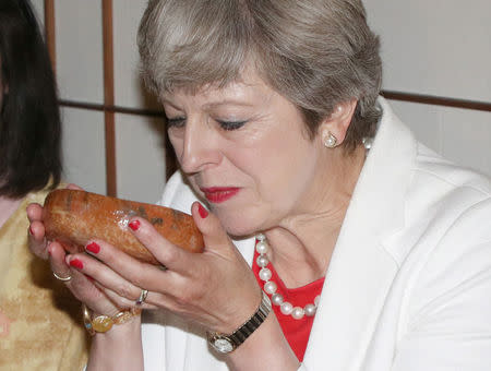 British Prime Minister Theresa May (R) takes part in a tea ceremony with Japanese Prime Minister Shinzo Abe (not in picture) at Omotesenke Fushin'an in Kyoto, western Japan August 30, 2017. REUTERS/Hirofumi Yamamoto/Pool