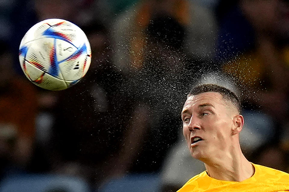 Australia's Mitchell Duke heads the ball during the World Cup group D soccer match against Denmark, at the Al Janoub Stadium in Al Wakrah, Qatar, Wednesday, Nov. 30, 2022. (AP Photo/Aijaz Rahi)