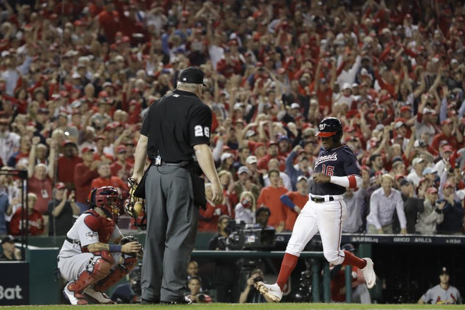 Washington Nationals' Victor Robles scores on a single by Adam Eaton during the third inning of Game 3 of the baseball National League Championship Series against the St. Louis Cardinals Monday, Oct. 14, 2019, in Washington. (AP Photo/Jeff Roberson)