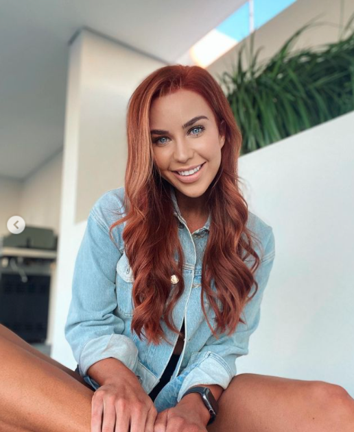 Coco Stedman with red hair wearing a denim jacket