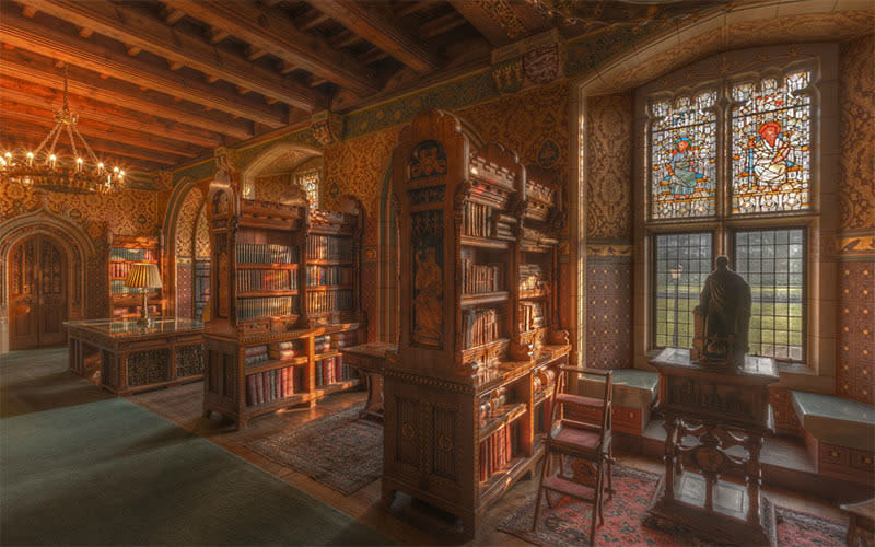 <b>Cardiff Castle Library </b> features incredibly intricate details surrounding the elaborately decorated shelves, each full of row after row of colourfully bound old books.