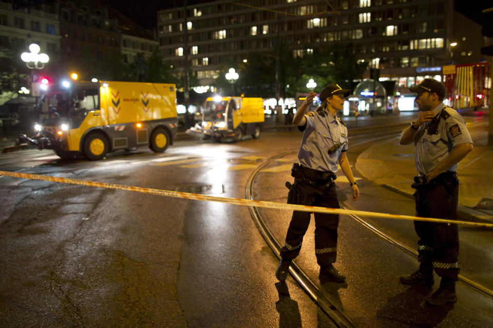 FILE- Police officers secure the area as road sweeping vehicles clear glass near the site of Friday's explosion in Oslo, Norway, in this file photo dated Saturday, July 23, 2011. A homegrown terrorist set off the explosion that ripped open buildings in the heart of Norway's government, then went to a summer camp dressed as a police officer and gunned down dozens of youths at a Norwegian summer camp. It is announced Friday March 30, 2012, that a loosely knit group of xenophobic "defense leagues" plans to rally in Denmark upcoming Saturday against what they call the growing Islamic presence in western Europe, with fears across Europe that a growing climate of ethnic and religious hostility is inspiring extremist violence, and creating the conditions for deadly unpredictable clashes. (AP Photo/Matt Dunham, FILE)