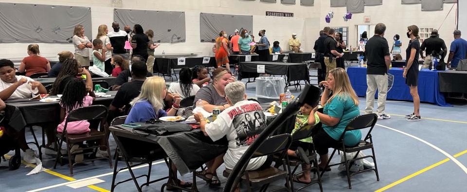 A group of people visiting information tables and eating at a Oak Ridge/Anderson County NAACP sponsored Back-to-School Fair. Now the local chapter of the NAACP has a Black history contest underway.